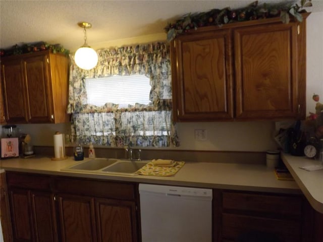 kitchen featuring dishwasher, pendant lighting, and sink