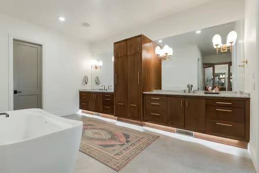 bathroom with vanity and a bath