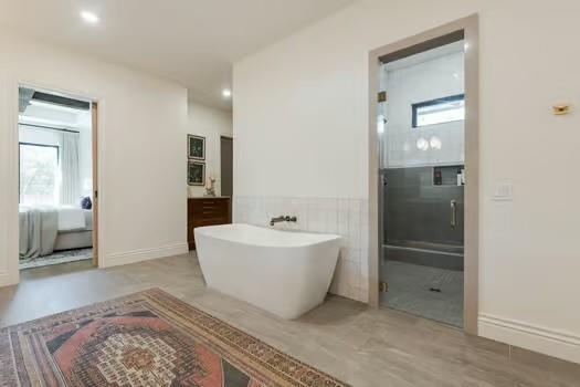 bathroom with vanity and independent shower and bath