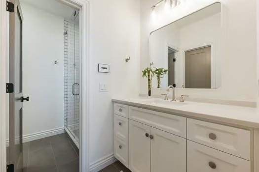 bathroom featuring vanity and an enclosed shower