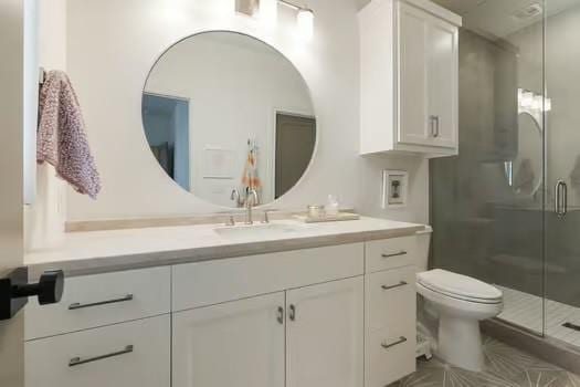 bathroom with vanity, toilet, and walk in shower