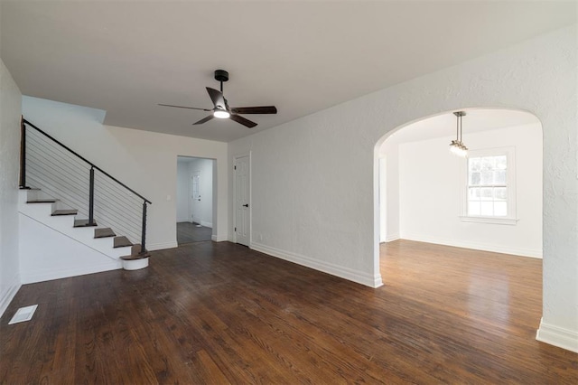 empty room featuring ceiling fan and dark wood-type flooring