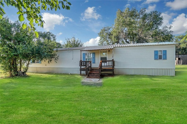 rear view of house featuring a yard