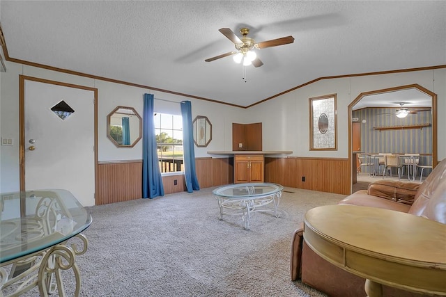 living room with a textured ceiling, carpet floors, ceiling fan, and lofted ceiling