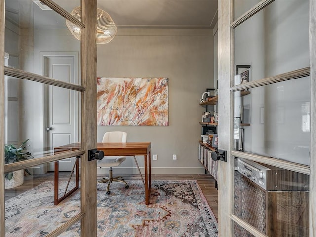 office with crown molding and hardwood / wood-style flooring