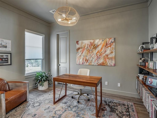 office area featuring a chandelier, crown molding, and wood-type flooring