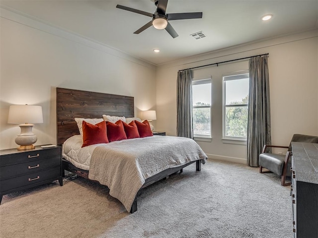 carpeted bedroom featuring ceiling fan and ornamental molding