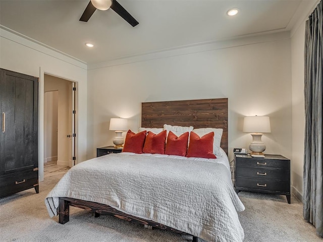 bedroom featuring light colored carpet, ceiling fan, and ornamental molding