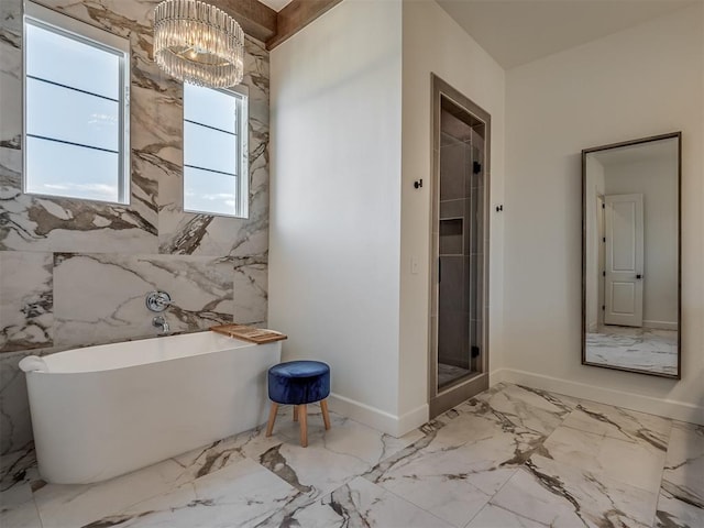 bathroom featuring separate shower and tub, tile walls, and a notable chandelier