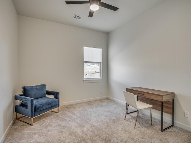 living area with ceiling fan and light colored carpet