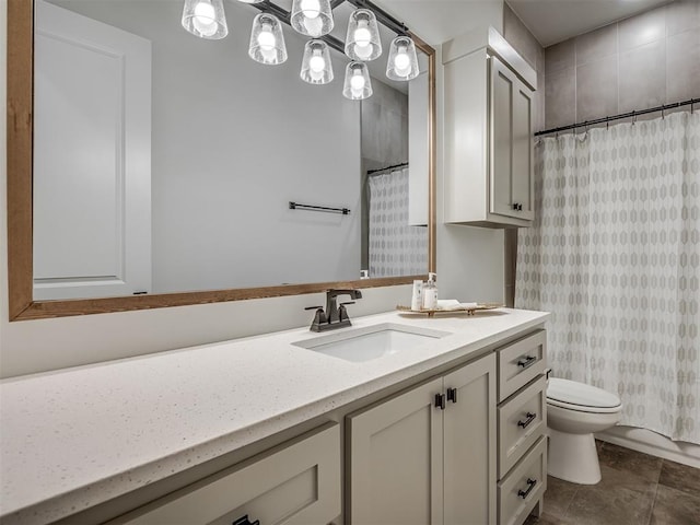 bathroom featuring tile patterned flooring, vanity, toilet, and curtained shower