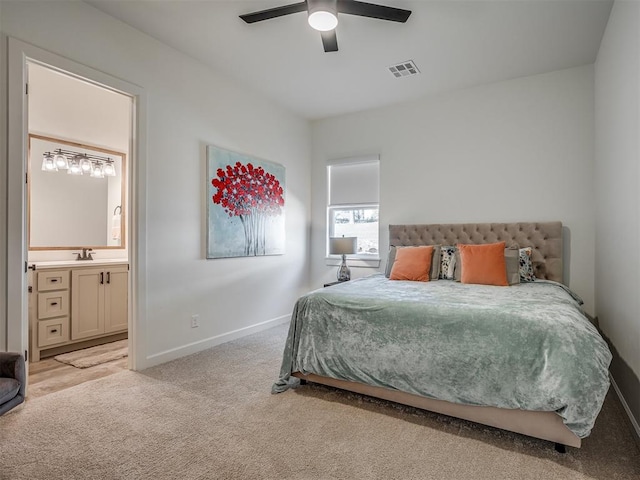 carpeted bedroom with connected bathroom, ceiling fan, and sink