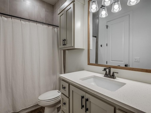 bathroom featuring a shower with curtain, vanity, and toilet