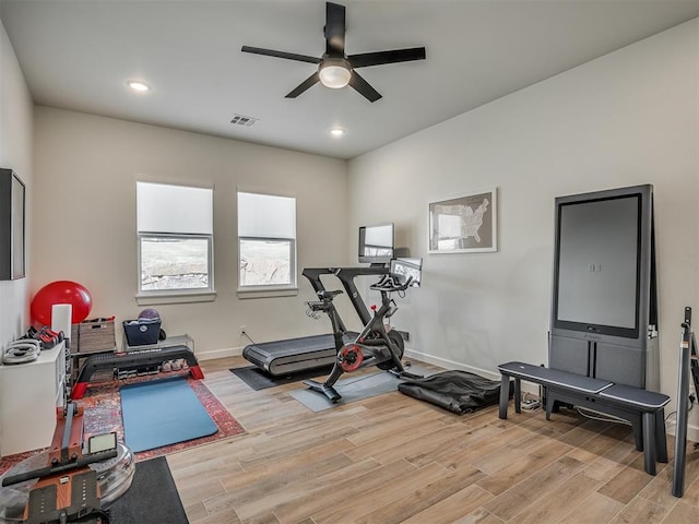 exercise area with ceiling fan and light hardwood / wood-style floors