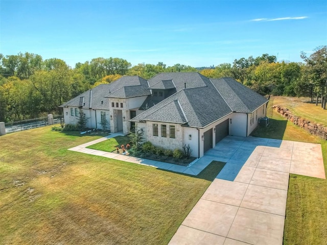 view of front of property with a front yard and a garage