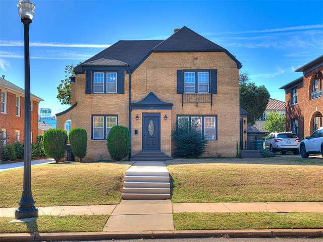 view of property featuring a front lawn