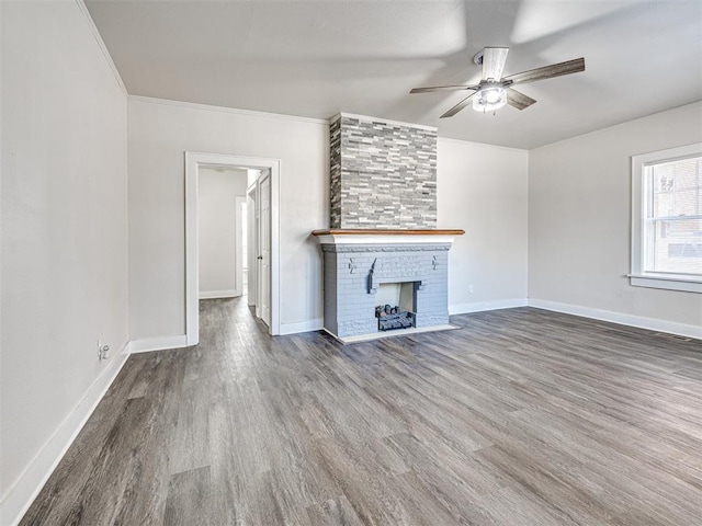 unfurnished living room with a fireplace, hardwood / wood-style floors, and ornamental molding