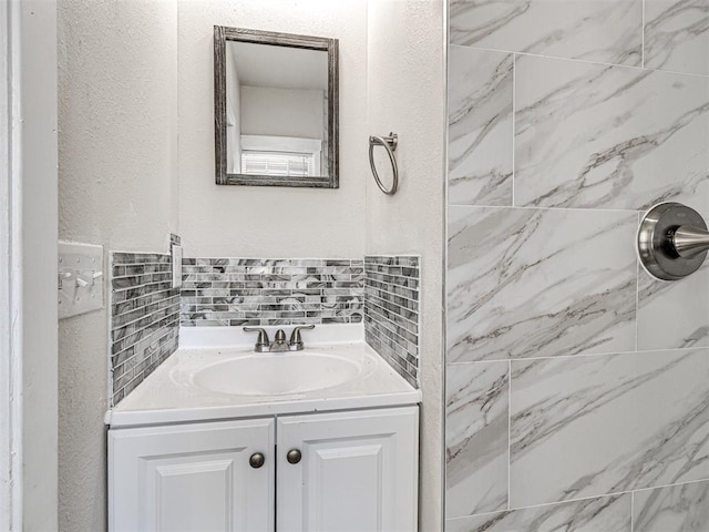 bathroom with vanity and tiled shower