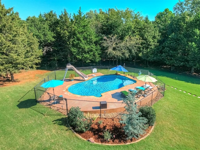 view of pool featuring a lawn and a water slide