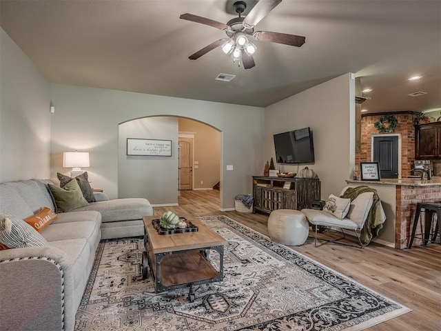 living room with ceiling fan and light wood-type flooring