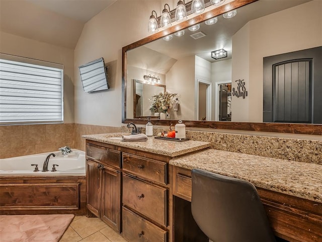 bathroom featuring tile patterned floors, vanity, lofted ceiling, and a bath