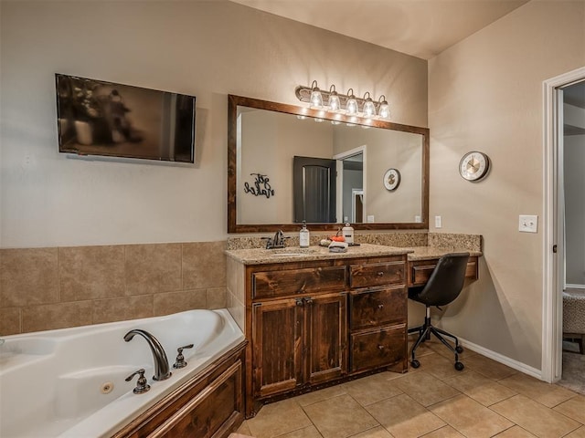 bathroom featuring tile patterned floors, a bathing tub, and vanity