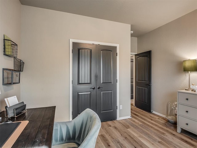 office area with light hardwood / wood-style floors