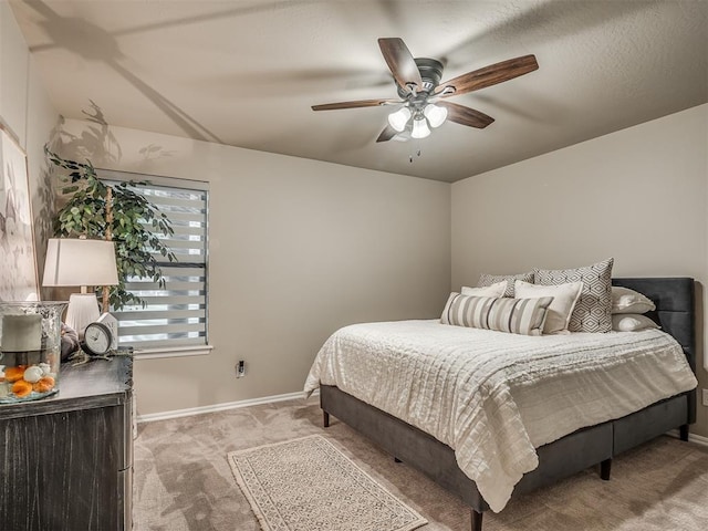 bedroom with ceiling fan and light colored carpet