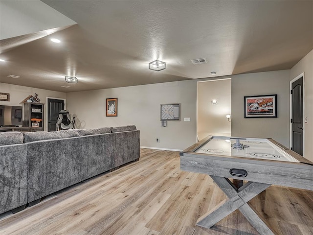 playroom with light hardwood / wood-style floors