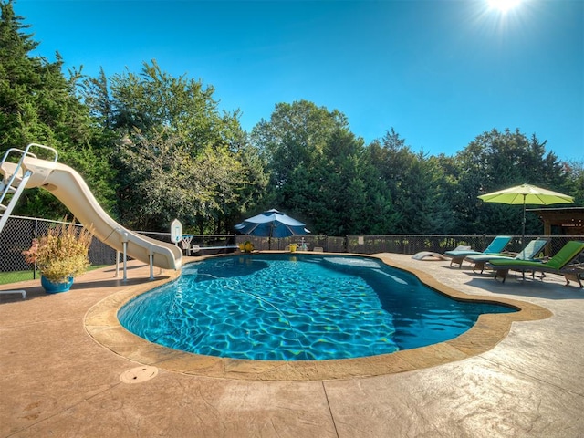 view of swimming pool featuring a patio and a water slide