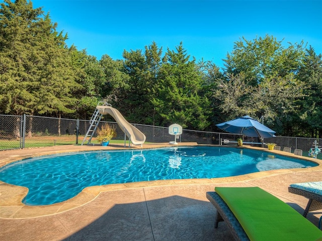 view of pool with a patio and a water slide