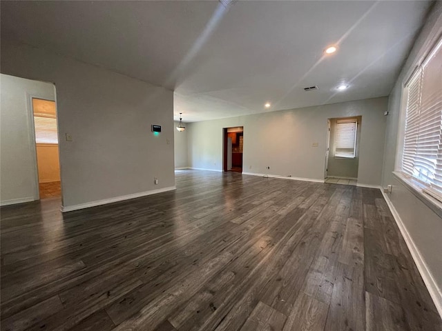 unfurnished living room with dark hardwood / wood-style floors