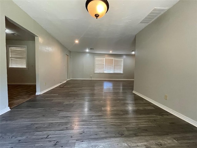 spare room with dark wood-type flooring