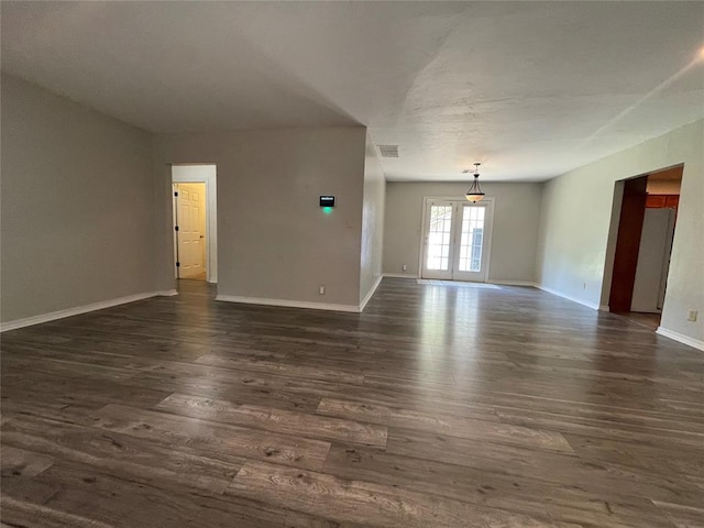 unfurnished room featuring french doors and dark hardwood / wood-style flooring