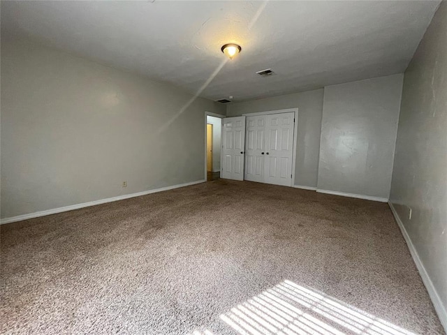 unfurnished bedroom with a closet and carpet