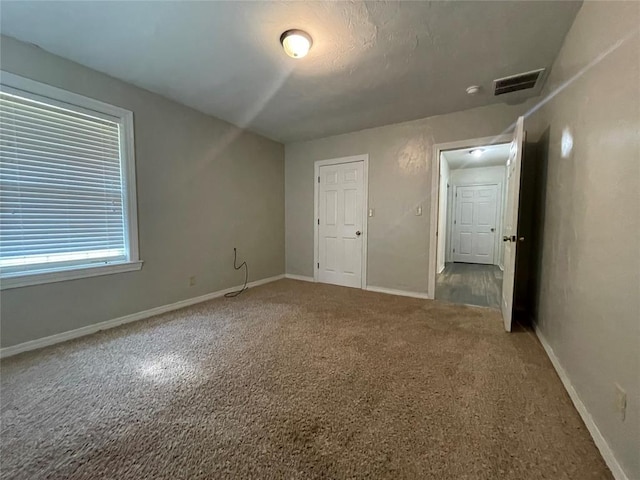 unfurnished bedroom with carpet floors