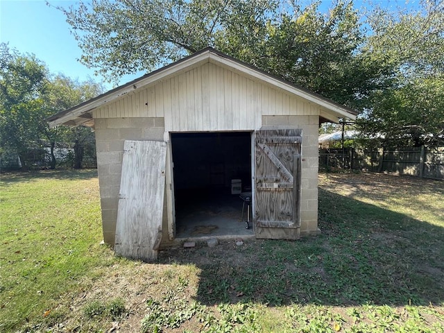 view of outdoor structure featuring a lawn