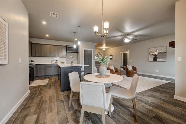 dining room with ceiling fan and sink