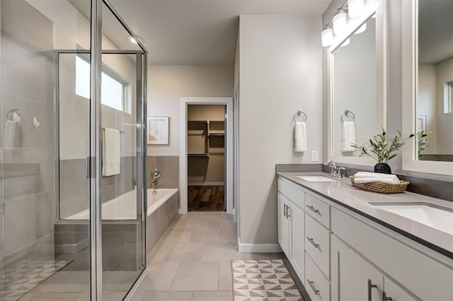 bathroom featuring separate shower and tub, vanity, and tile patterned floors