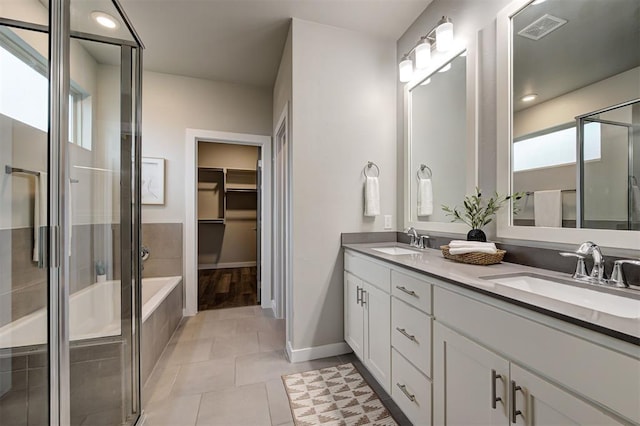 bathroom with separate shower and tub, vanity, and tile patterned flooring