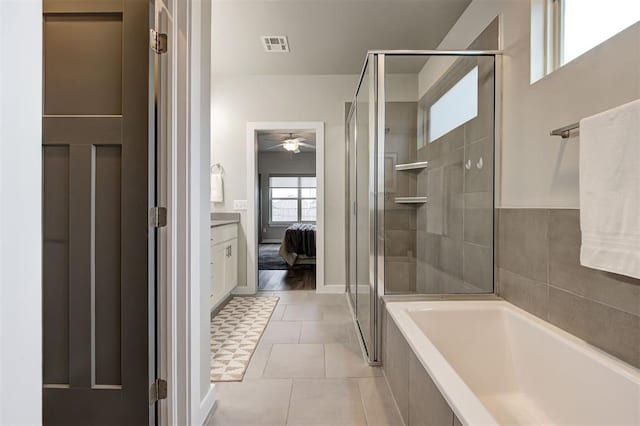 bathroom featuring vanity, separate shower and tub, and tile patterned flooring