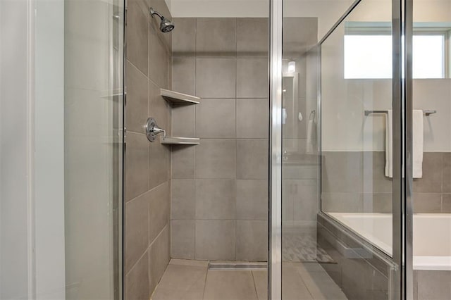 bathroom featuring shower with separate bathtub