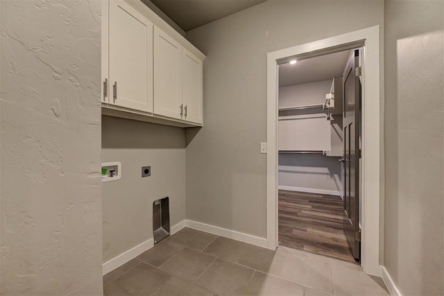 laundry room featuring tile patterned flooring, washer hookup, electric dryer hookup, and cabinets