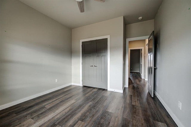 unfurnished bedroom with ceiling fan, a closet, and dark hardwood / wood-style floors