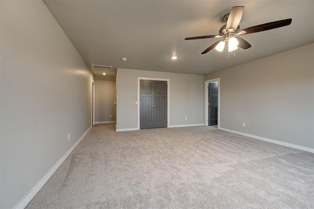 unfurnished bedroom with ceiling fan and light carpet