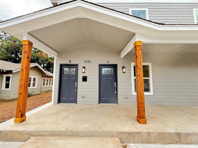 view of exterior entry with a porch