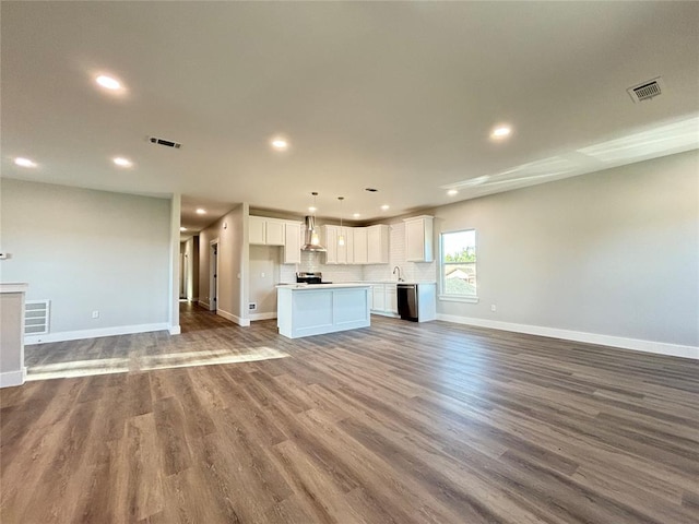 unfurnished living room with sink and wood-type flooring