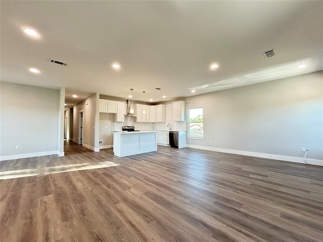 unfurnished living room with dark wood-type flooring