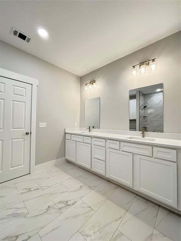 bathroom with a shower and vanity