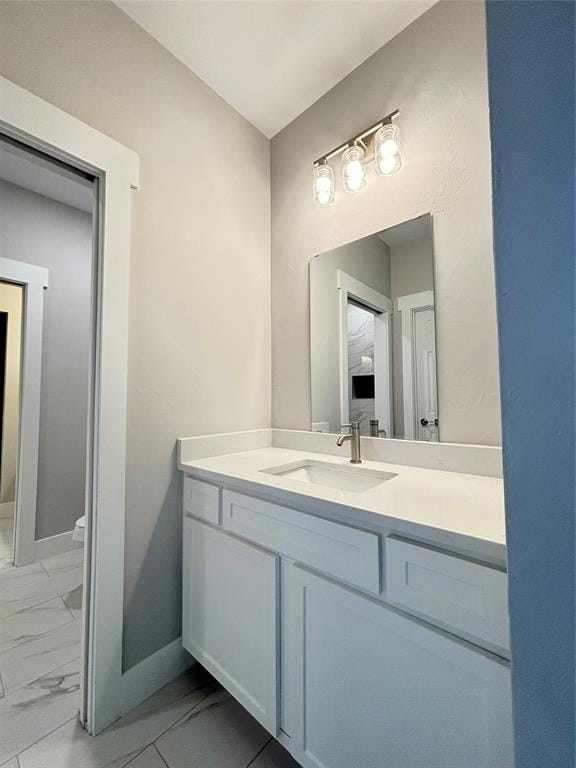 bathroom with vanity and toilet